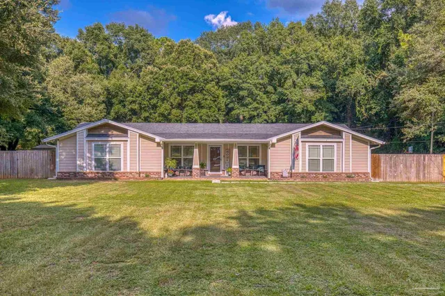 a front view of house with a garden and patio
