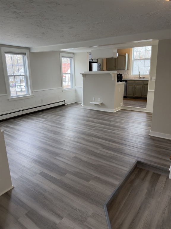 a view of living room and kitchen with wooden floor