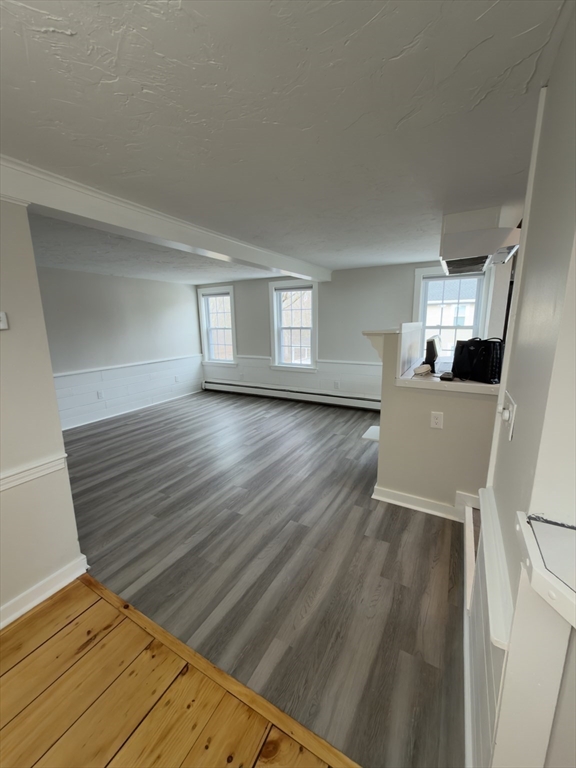 41 Sherman Street, Unit 2 Foxboro, MA 02035 - Photo 11 of 21 a view of empty room with wooden floor and window