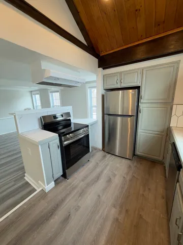 a kitchen with a refrigerator and a stove