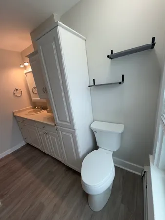 a bathroom with a toilet sink and mirror