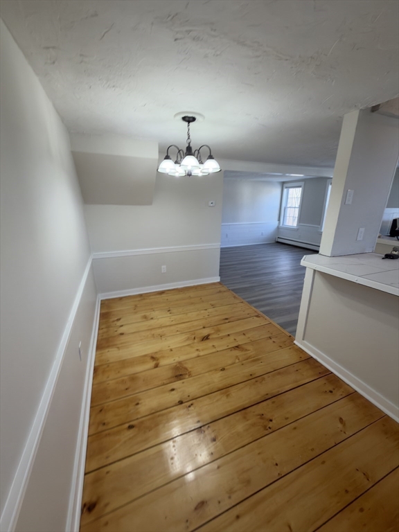 41 Sherman Street, Unit 2 Foxboro, MA 02035 - Photo 9 of 21 a bedroom with a bed and a chandelier