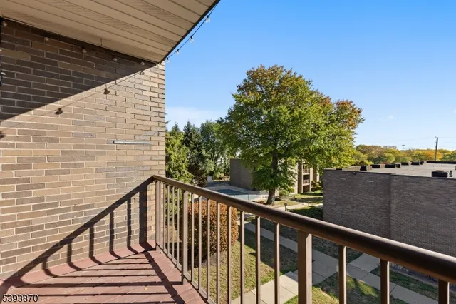 a view of balcony with wooden floor and fence