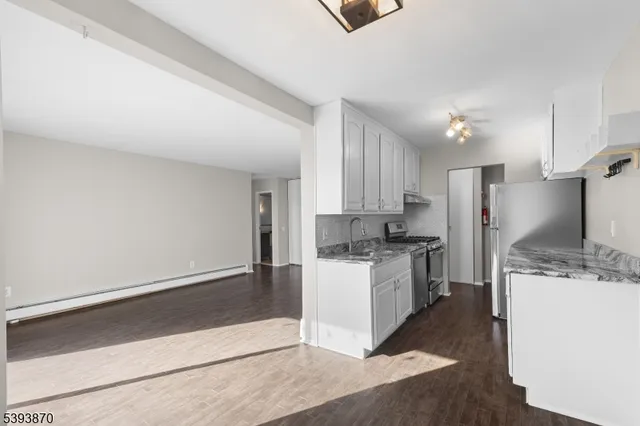 a kitchen with a stove a sink and a refrigerator