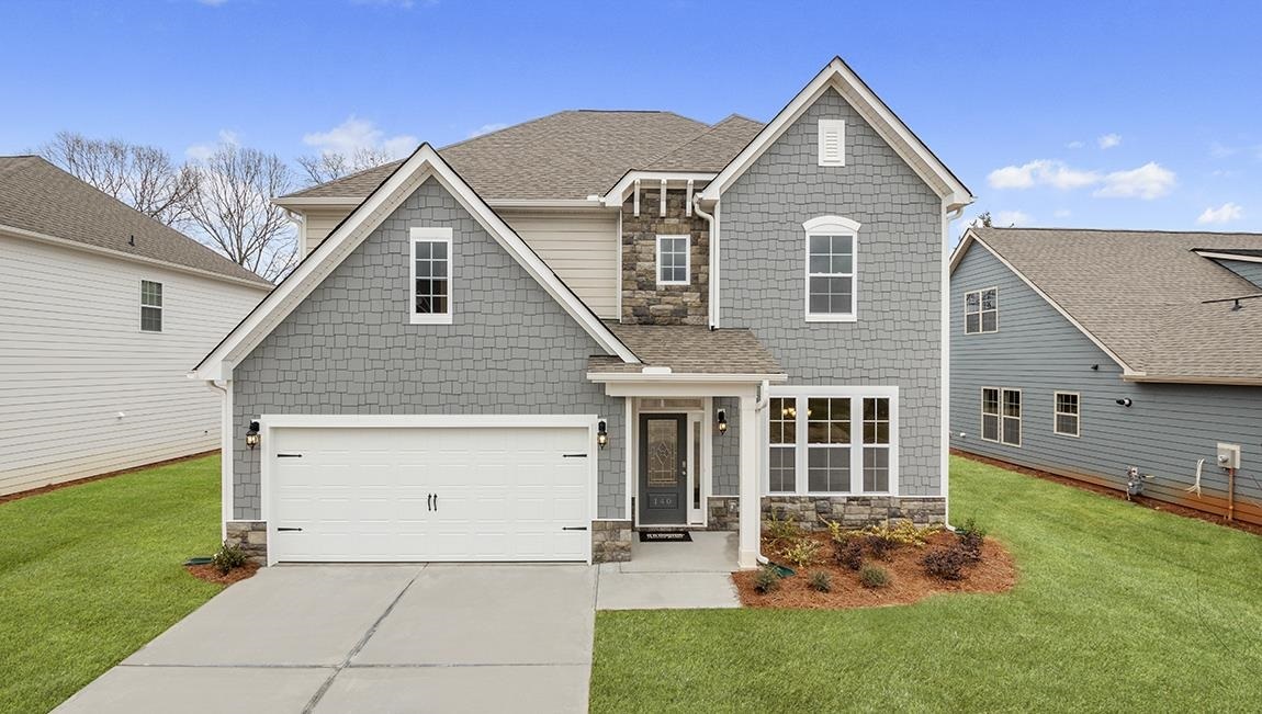 623 Edgar Street, Unit 15 Hampton, GA 30228 - Photo 1 of 1 a front view of a house with a yard