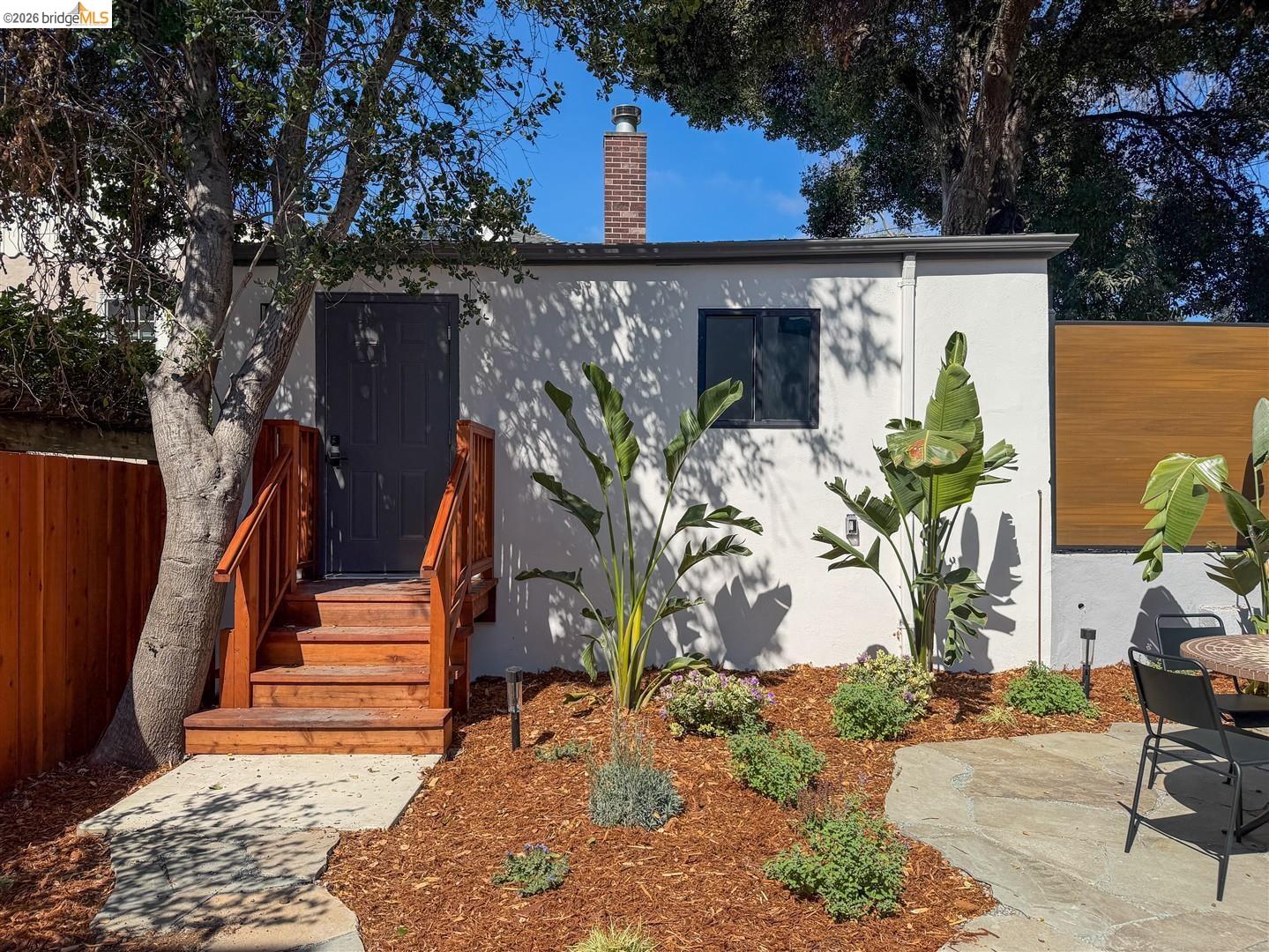 1668 Arch Street Berkeley, CA 94709 - Photo 50 of 78 Exterior stucco finish with a prominent brick chimney