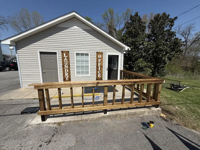 a view of a house with a window and wooden fence