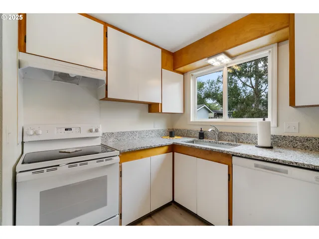 a kitchen with appliances cabinets and a sink