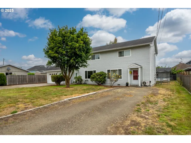 an aerial view of a house with yard