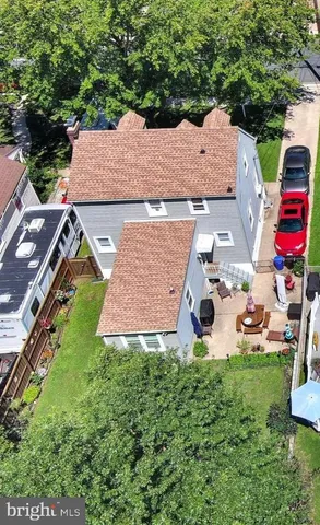 an aerial view of a house with garden space and street view