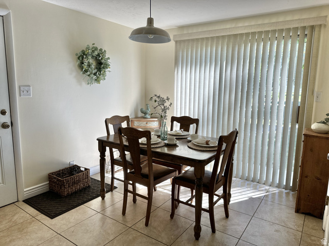624 East Cutler Springville, UT 84663 - Photo 9 of 24 Dining area featuring neutral-toned tile flooring and a patio door with vertical blinds