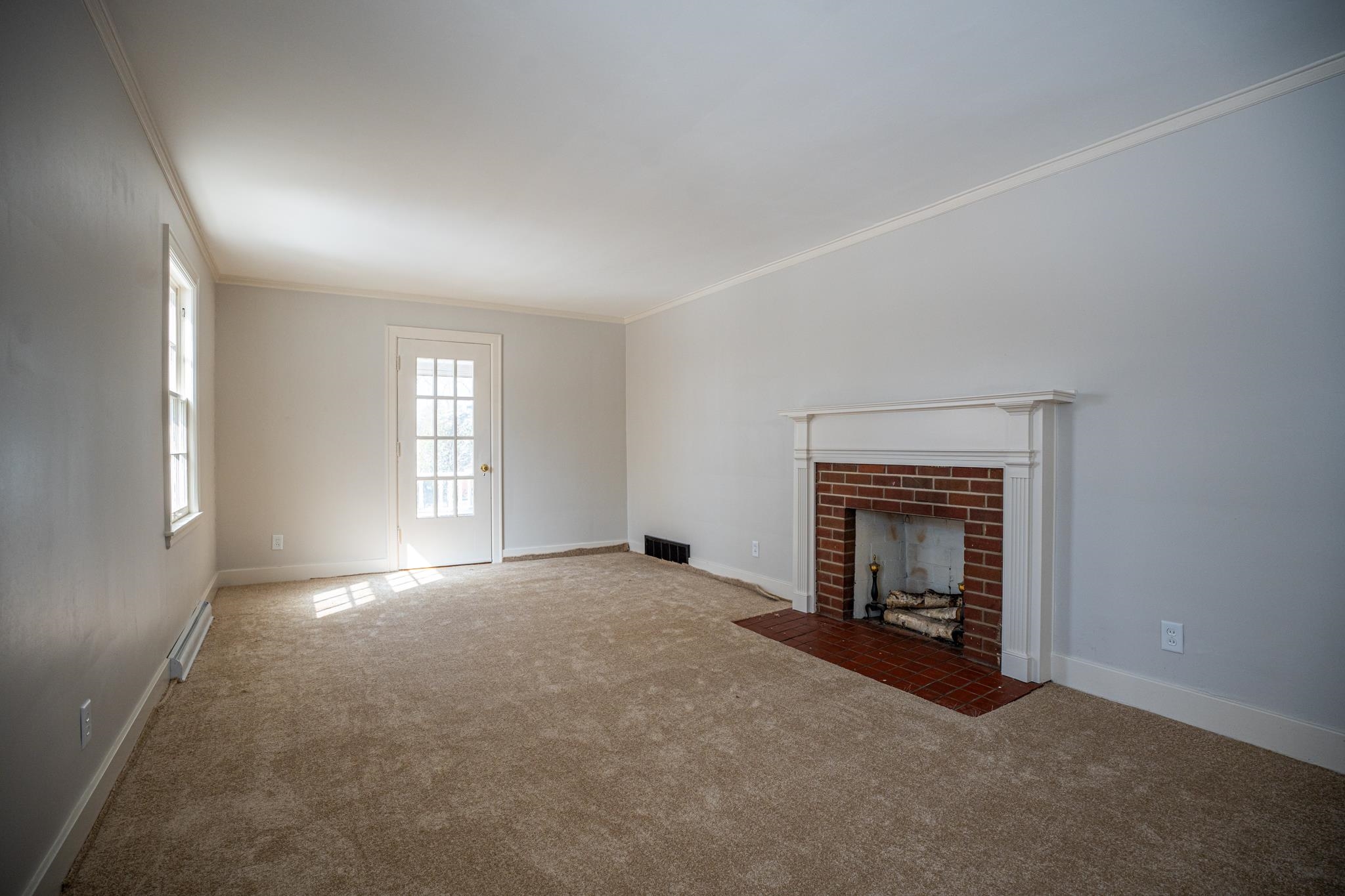 1070 North 8th Street Rochelle, IL 61068 - Photo 16 of 66 an empty room with windows and fireplace