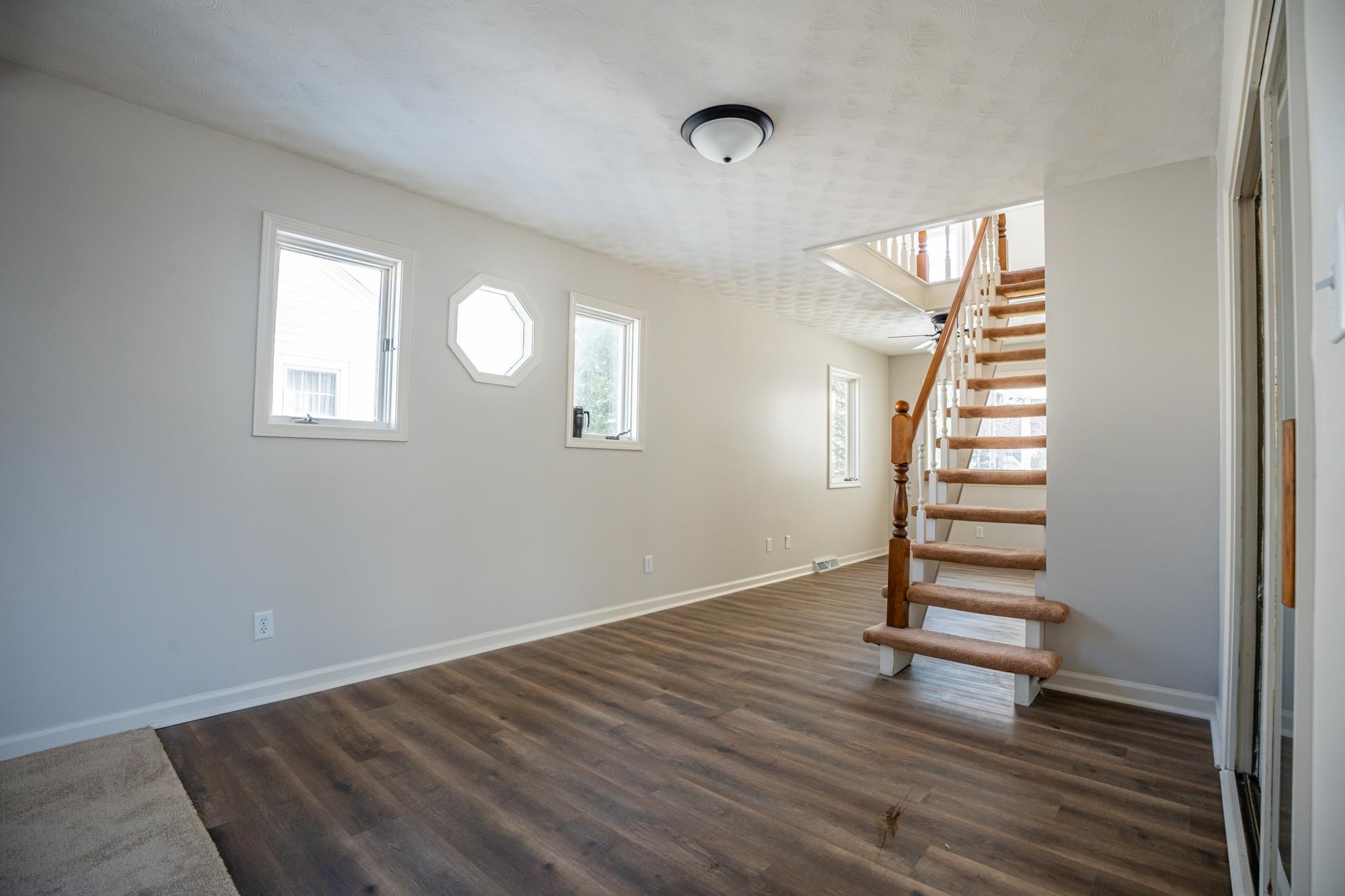 1070 North 8th Street Rochelle, IL 61068 - Photo 24 of 66 an empty room with wooden floor and windows
