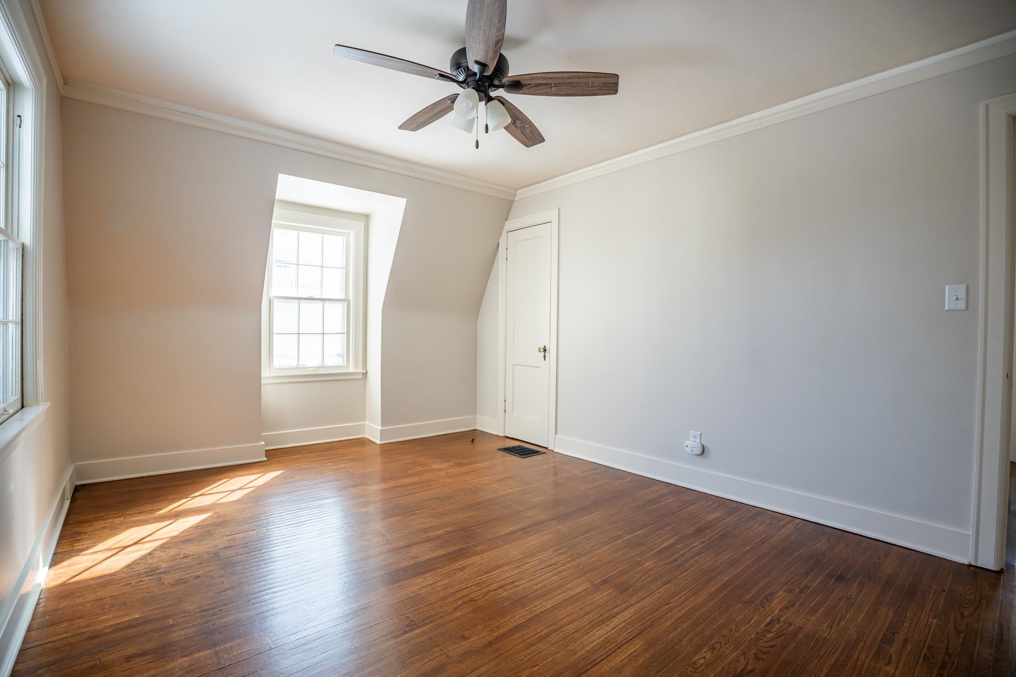1070 North 8th Street Rochelle, IL 61068 - Photo 41 of 66 an empty room with wooden floor fan and windows