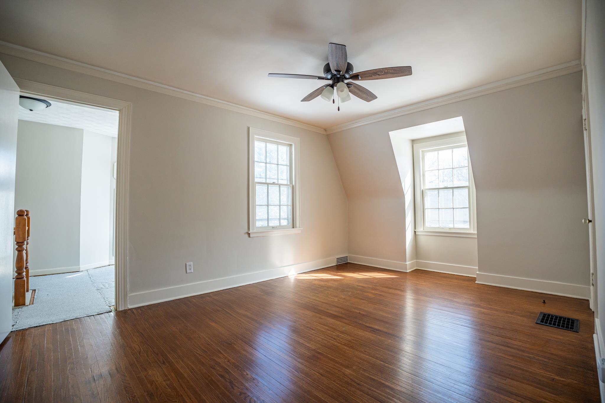 1070 North 8th Street Rochelle, IL 61068 - Photo 42 of 66 a view of an empty room with wooden floor and a window