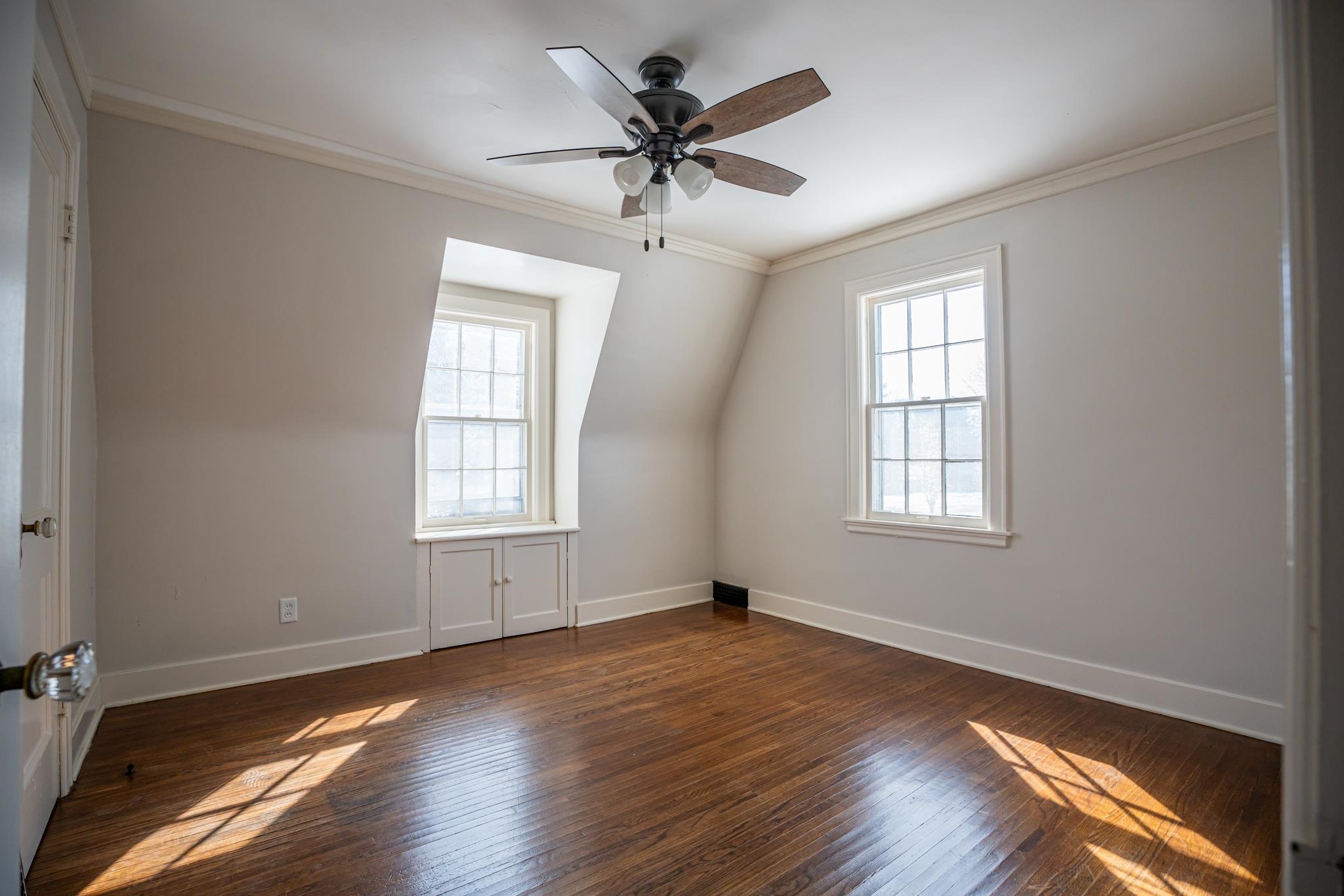1070 North 8th Street Rochelle, IL 61068 - Photo 45 of 66 an empty room with wooden floor chandelier fan and windows
