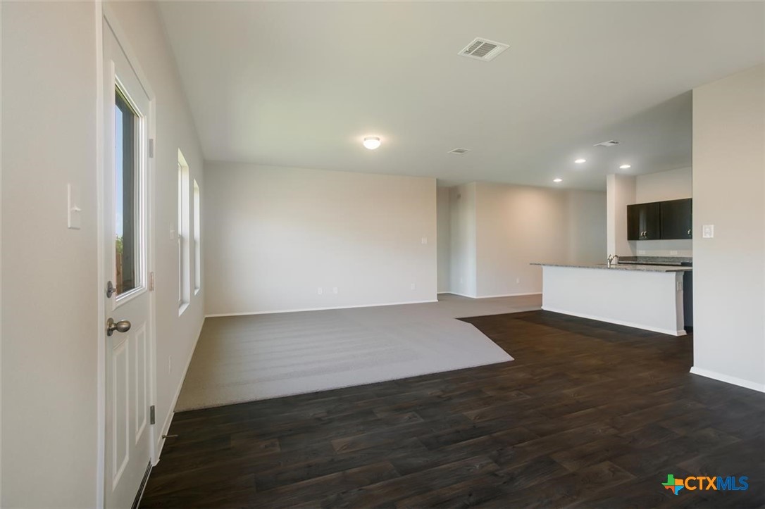 2428 Ambling Trail Georgetown, TX 78628 - Photo 11 of 33 a view of a livingroom with a kitchen counter tops and white wooden floor