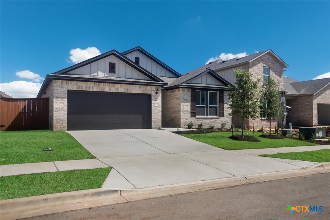 2428 Ambling Trail Georgetown, TX 78628 - Photo 2 of 33 a front view of a house with a yard and garage
