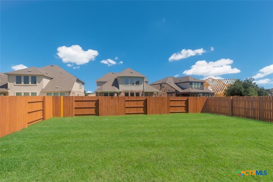 2428 Ambling Trail Georgetown, TX 78628 - Photo 25 of 33 a view of a house with a yard