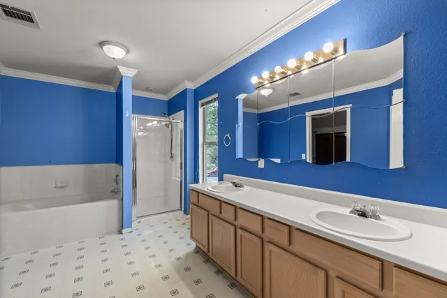 a large bathroom with a sink a large mirror and a bathtub