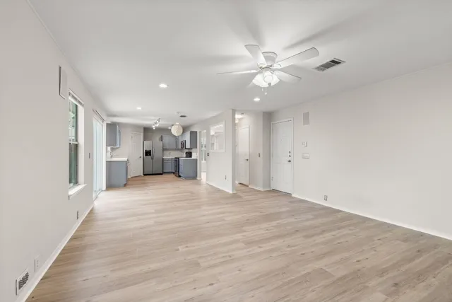 a view of empty room with wooden floor