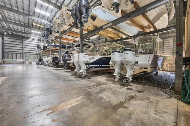 a view of swimming pool with outdoor seating and house in the background