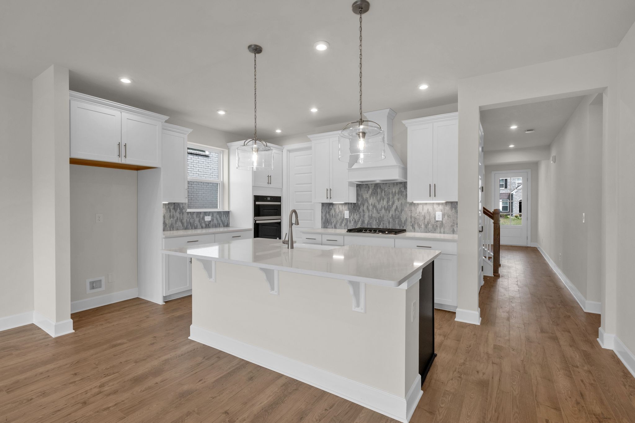 263 Pin High Drive Mount Juliet, TN 37122 - Photo 2 of 34 a large kitchen with stainless steel appliances kitchen island a refrigerator a stove a sink dishwasher a oven with white cabinets and wooden floor