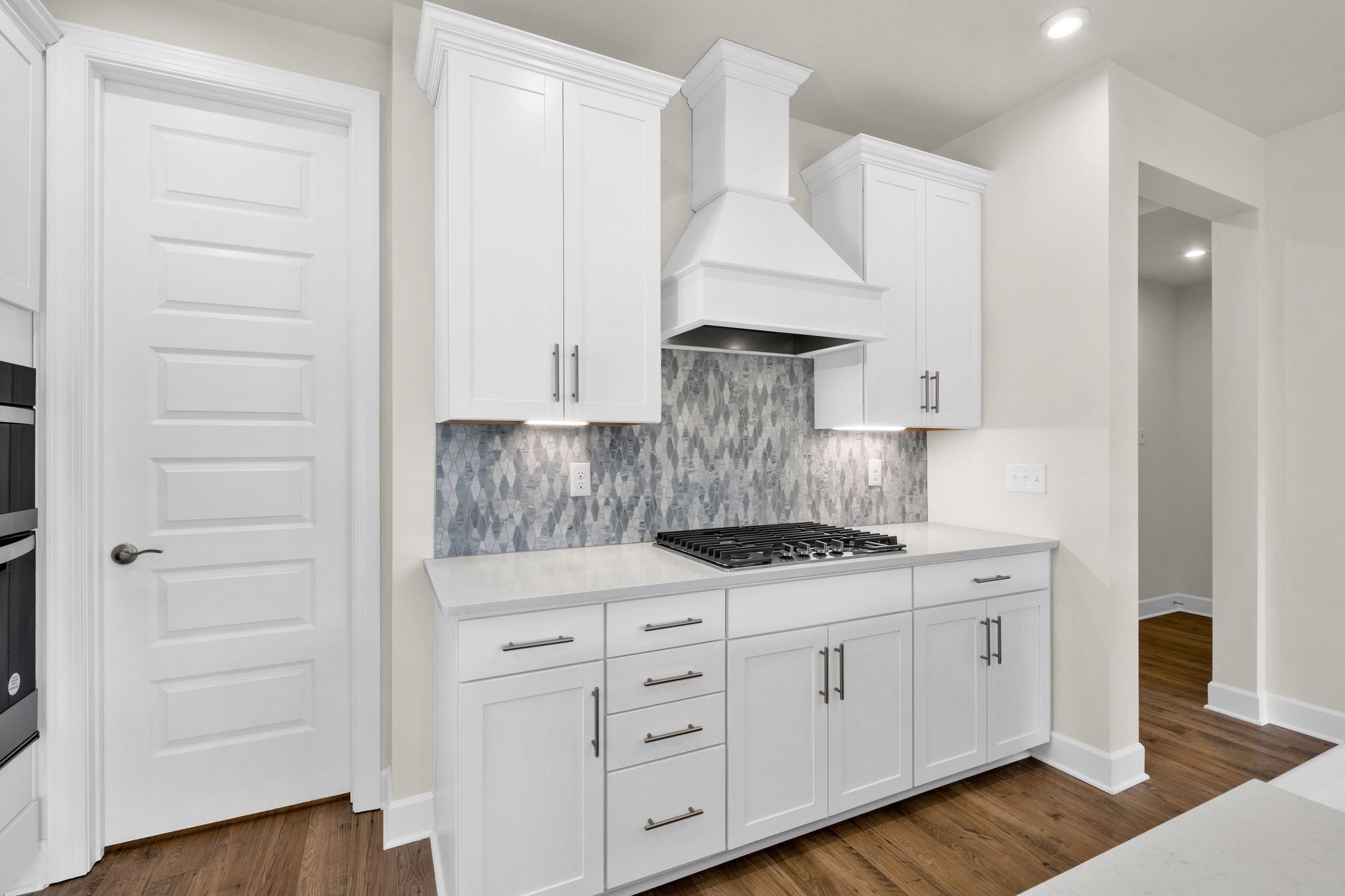 263 Pin High Drive Mount Juliet, TN 37122 - Photo 4 of 34 a kitchen with white cabinets and a stove with wooden floor