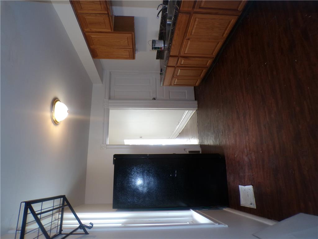 111 Ridge Avenue Allentown, PA 18102 - Photo 5 of 15 A classic eat in kitchen with rich wood flooring and functional cabinetry awaits culinary adventures. View from rear covered porch