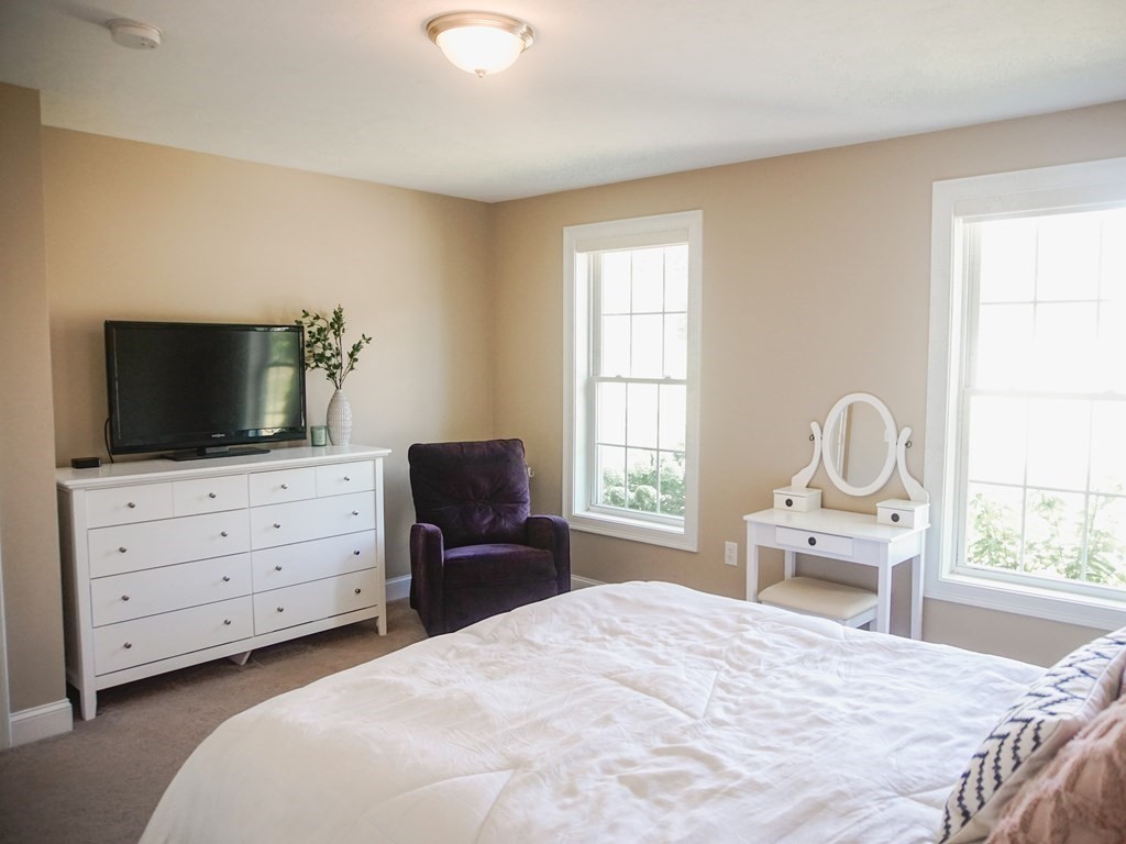 206 Haymeadow Lane Ayer, MA 01432 - Photo 16 of 41 a bedroom with a bed and flat screen tv