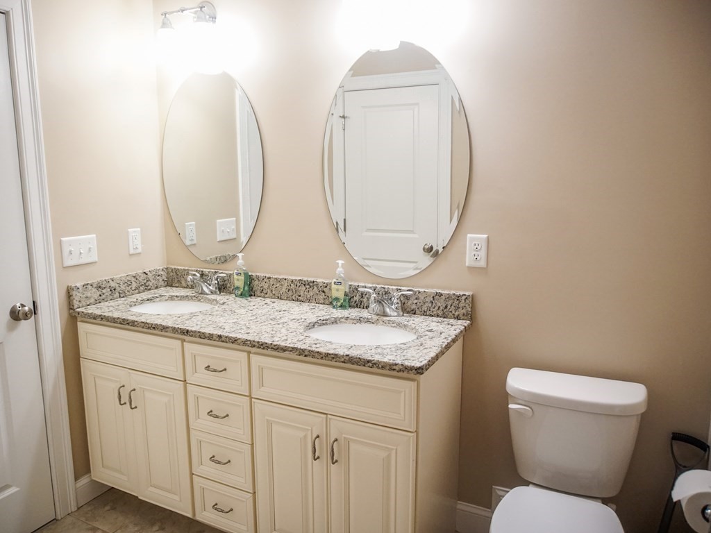 206 Haymeadow Lane Ayer, MA 01432 - Photo 17 of 41 a bathroom with a granite countertop toilet a sink and a mirror