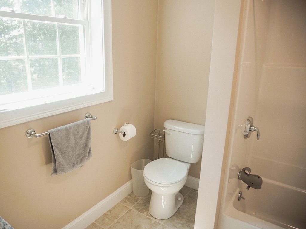 206 Haymeadow Lane Ayer, MA 01432 - Photo 29 of 41 a white toilet sitting next to a bathroom sink