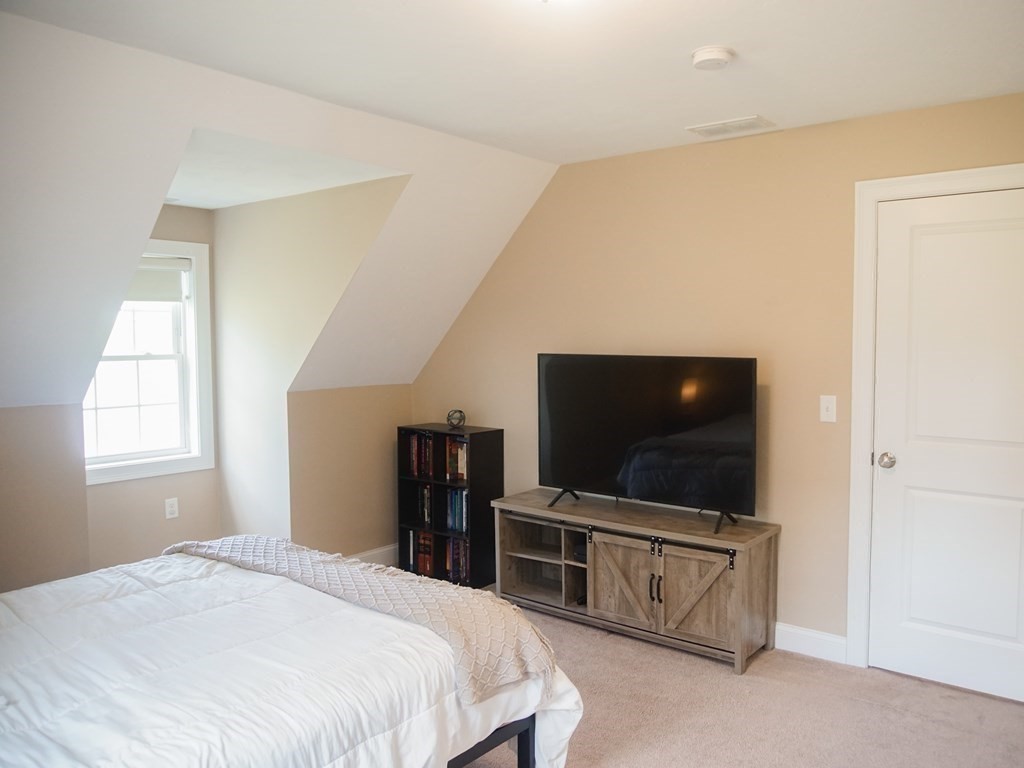 206 Haymeadow Lane Ayer, MA 01432 - Photo 33 of 41 a bedroom with bed and flat screen tv