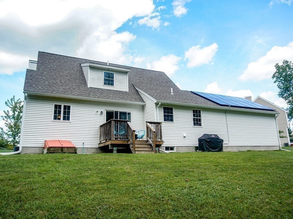 206 Haymeadow Lane Ayer, MA 01432 - Photo 37 of 41 a front view of a house with a garden and plants