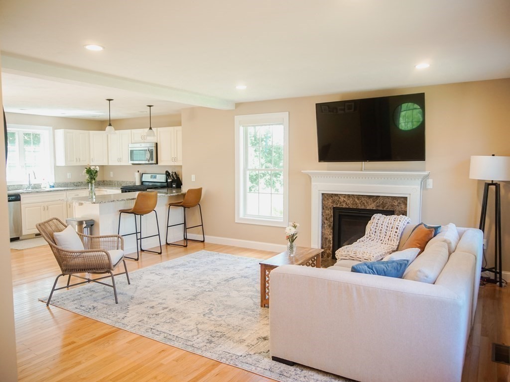 206 Haymeadow Lane Ayer, MA 01432 - Photo 6 of 41 a living room with furniture fireplace and a flat screen tv
