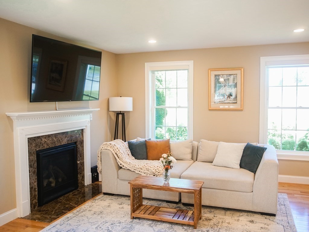 206 Haymeadow Lane Ayer, MA 01432 - Photo 7 of 41 a living room with furniture and a fireplace