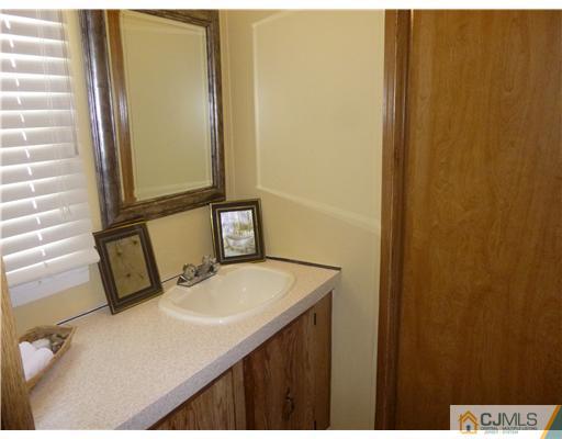 22-22 Longfellow Road North Brunswick, NJ 08902 - Photo 6 of 9 a bathroom with a sink and a mirror
