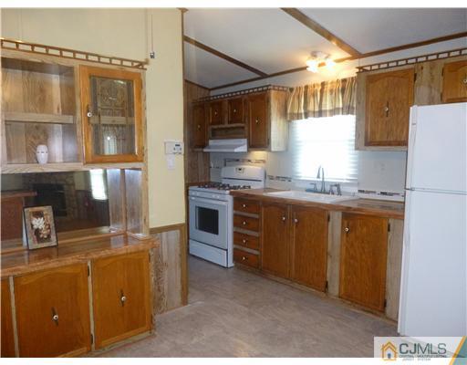 22-22 Longfellow Road North Brunswick, NJ 08902 - Photo 7 of 9 a kitchen with cabinets a sink and appliances