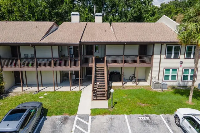 a aerial view of a house with a yard table and chairs