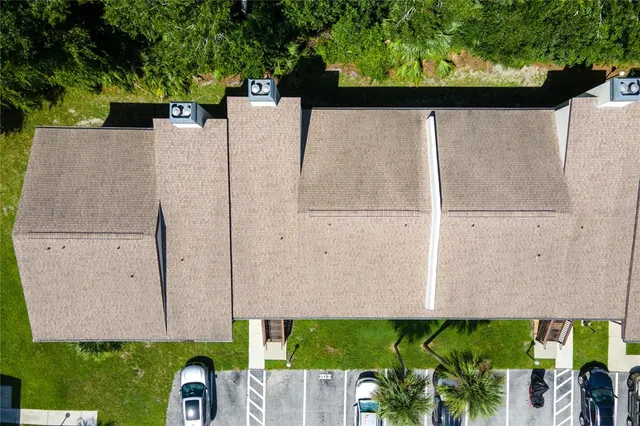 an aerial view of a house with a yard and lake view