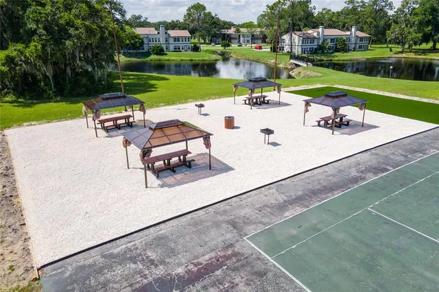 an outdoor sitting area with swimming pool and green space