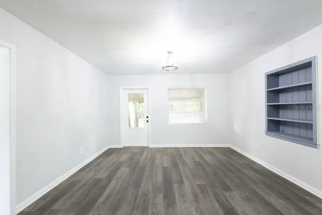 wooden floor in an empty room with a window