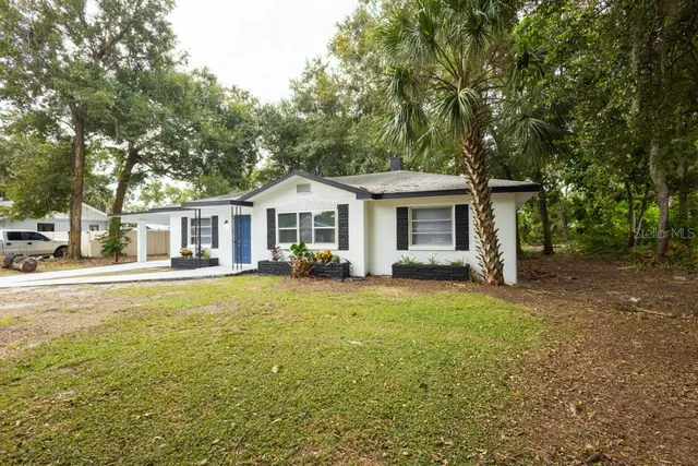 a front view of a house with a garden and porch