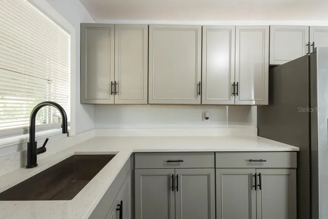 a view of a kitchen with white cabinets