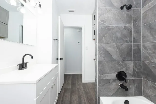 a bathroom with a sink and mirror