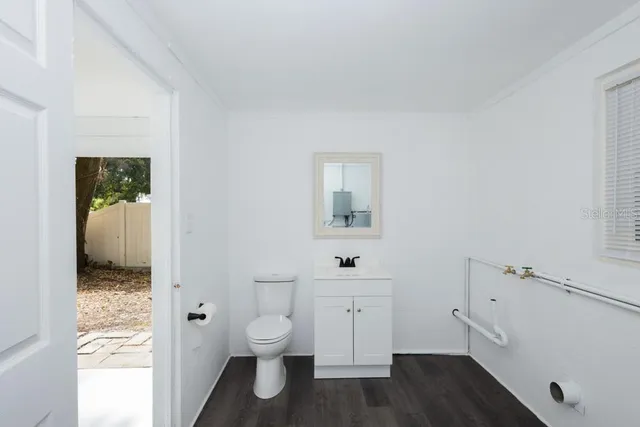 a bathroom with a toilet sink and a mirror