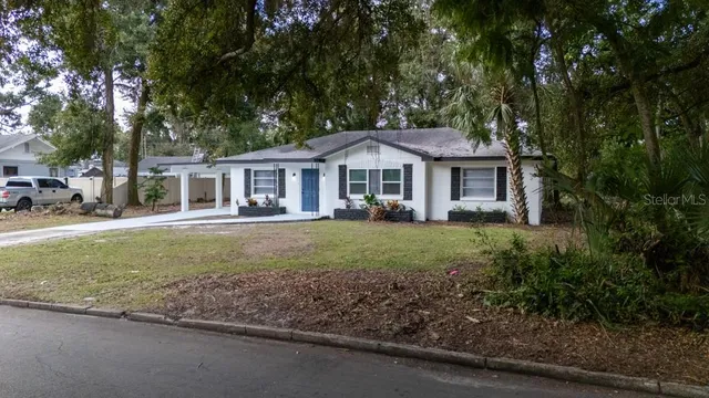 a front view of a house with a yard table and chairs
