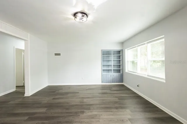 a view of an empty room with a window