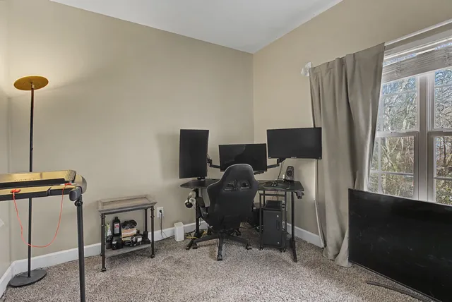 a view of a workspace with furniture and a window
