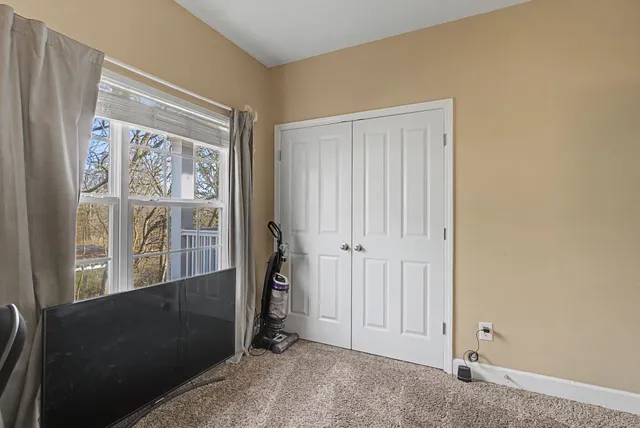 a view of a small space with wooden floor and a window
